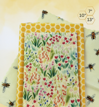 Load image into Gallery viewer, Set of three beeswax wraps that are 7 inch, 10 inch and 13 inches in size. Wraps are made of all natural ingredients including Alberta filtered beeswax.