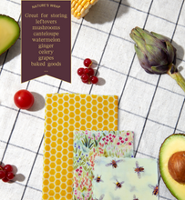Load image into Gallery viewer, three beeswax wraps displayed with assorted foods that keep fresher longer with all natural ingredients
